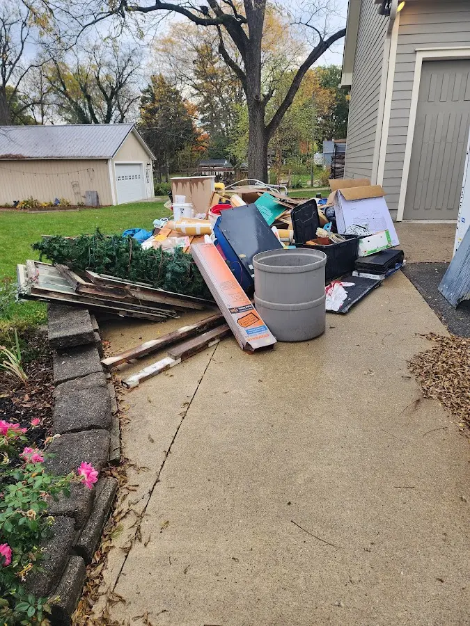 Dumpster being loaded with debris for Commercial Dumpster Rental in O'Fallon